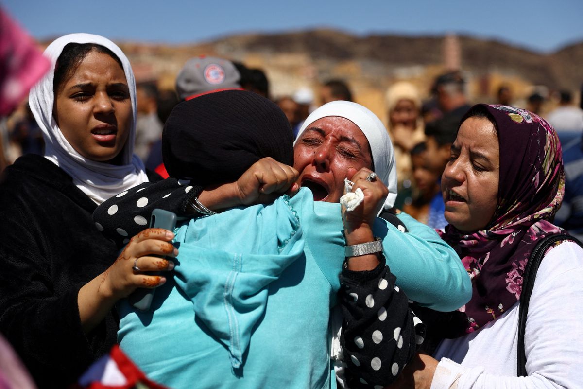 People react during the funeral of two victims of the deadly earthquake, in Moulay Brahim, Morocco.