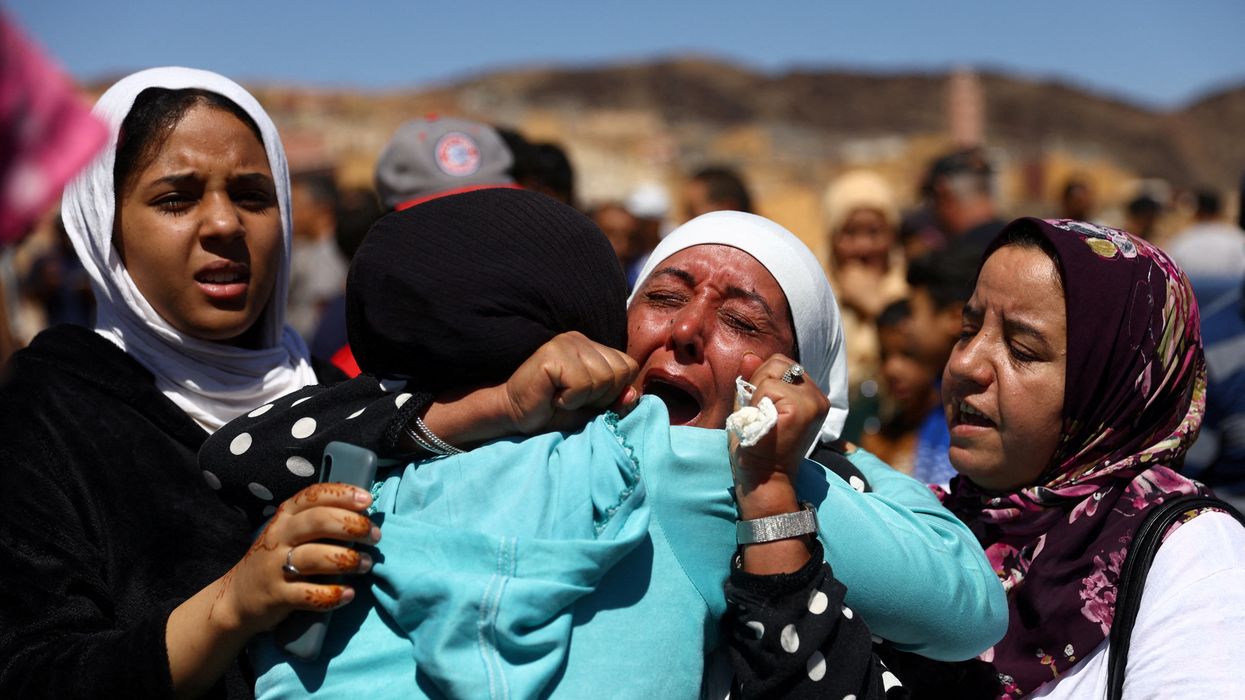 People react during the funeral of two victims of the deadly earthquake, in Moulay Brahim, Morocco.