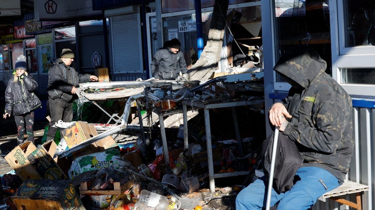 People remove debris at a food market following, what local Russian-installed authorities say, was a Ukrainian military strike in the course of Russia-Ukraine conflict in Donetsk, Russian-controlled Ukraine, January 21, 2024.