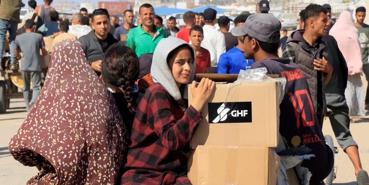 ​People ride a cart as Palestinians seeking aid gather near an aid distribution site run by the U.S.-backed Gaza Humanitarian Foundation, in Rafah, in the southern Gaza Strip, May 27, 2025. 