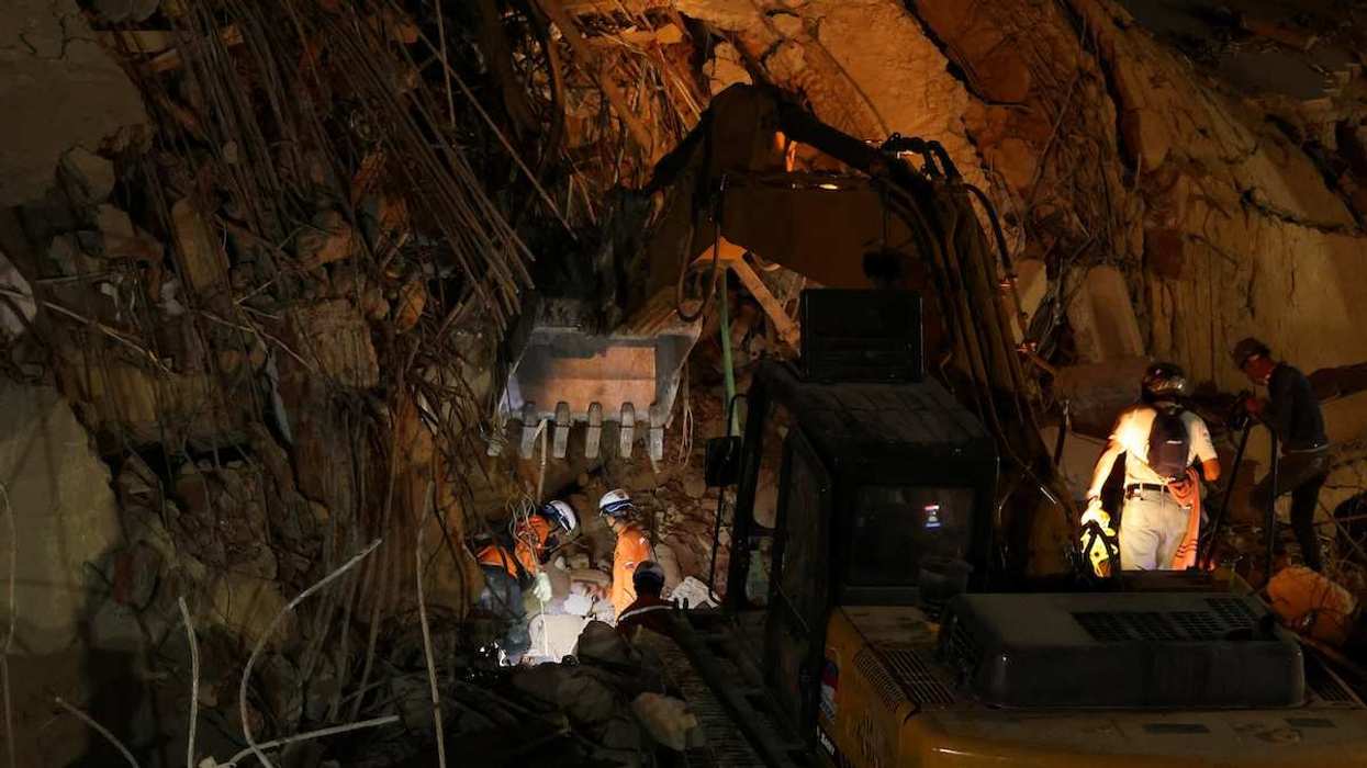 People search for casualties under the rubble of a collapsed building in Caracas following earthquakes in Venezuela, on June 25, 2026.