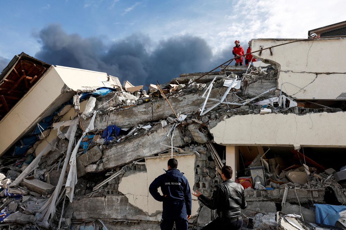 People search for survivors following an earthquake in Iskenderun, Turkey.