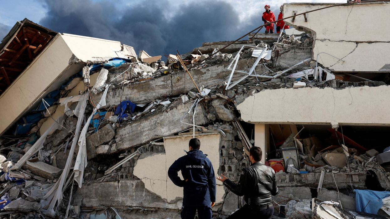 People search for survivors following an earthquake in Iskenderun, Turkey.
