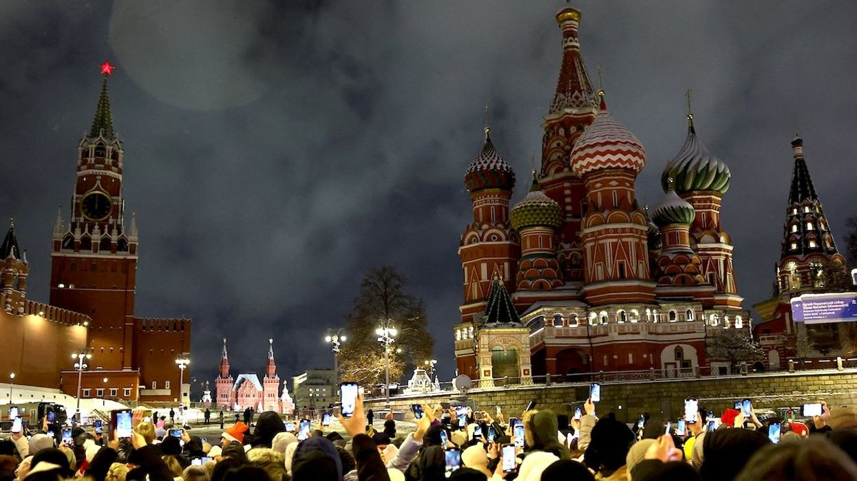 People take part in New Year celebrations near the Spasskaya Tower of the Kremlin and St. Basil’s Cathedral in central Moscow, Russia, on Jan. 1, 2025.