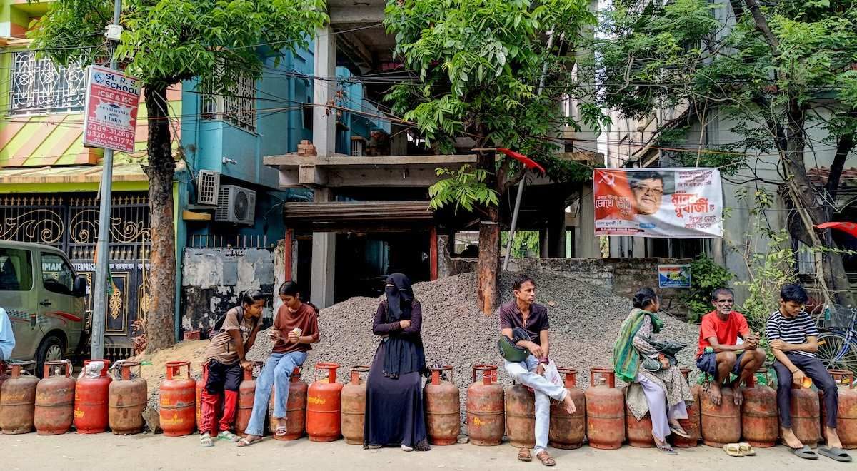 People wait in a long queue to buy liquefied petroleum gas (LPG) cylinders for domestic use outside a gas agency amid the reported nationwide shortage of LPG, in Kolkata on Monday.