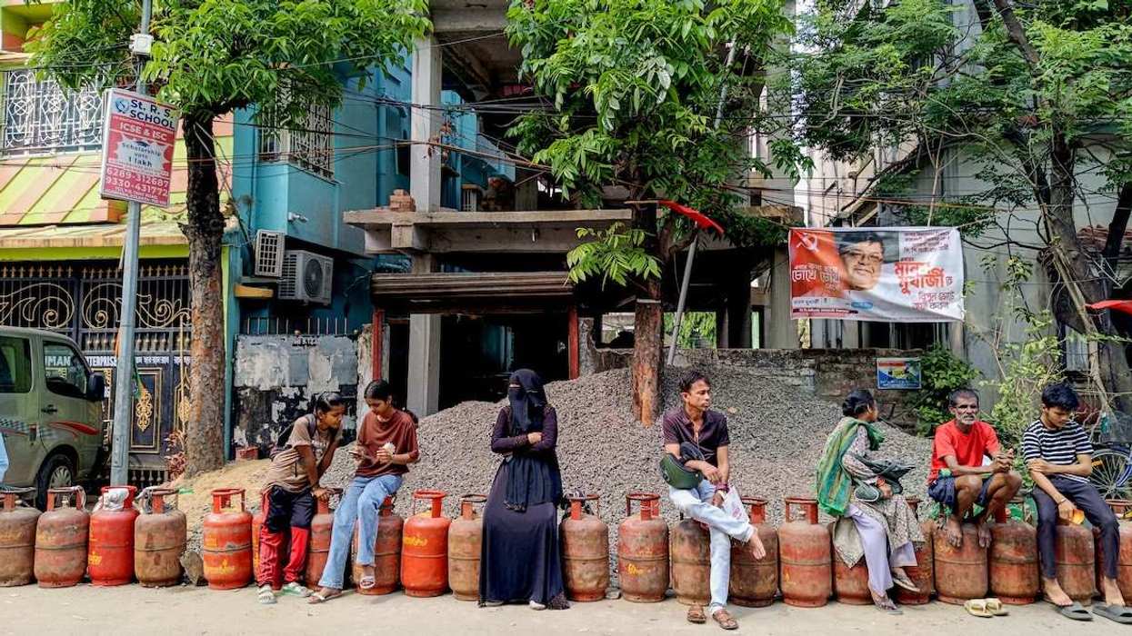 People wait in a long queue to buy liquefied petroleum gas (LPG) cylinders for domestic use outside a gas agency amid the reported nationwide shortage of LPG, in Kolkata on Monday.