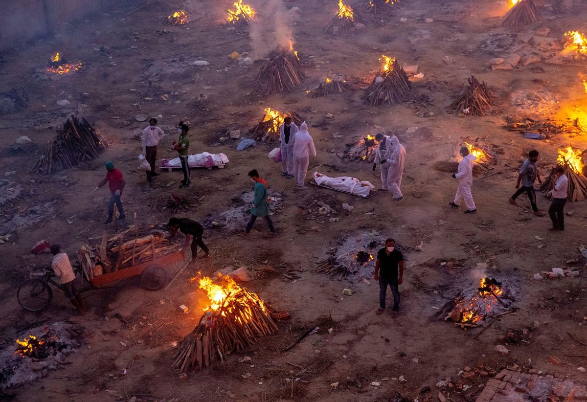 People wait to cremate victims who died due to the coronavirus disease (COVID-19), at a crematorium ground in New Delhi, India, April 23, 2021.