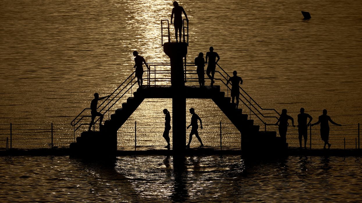 People wait to dive at the "bon secours" beach, as a heatwave hits France.