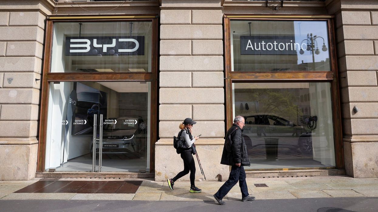 People walk in front of BYD Auto company and Autotorino store in Milan, Italy, March 20, 2024.