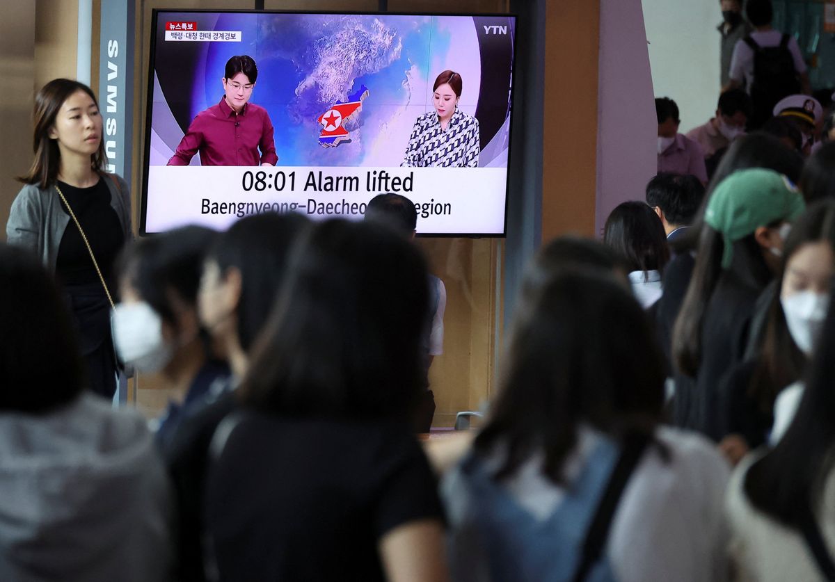 People watch a news report on North Korea firing what it called a space satellite toward the south, in Seoul, South Korea.