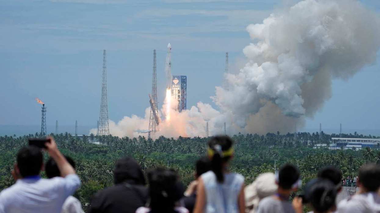 People watch as a Long March 10B carrier rocket takes off from Wenchang Spacecraft Launch Site, in Hainan province, China, on July 10, 2026.