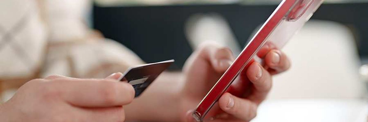 Person entering credit card details on a phone
