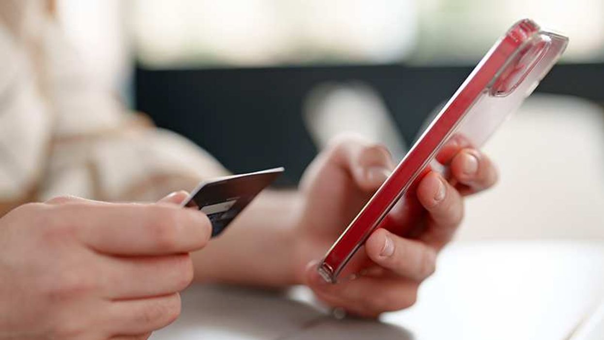 Person entering credit card details on a phone