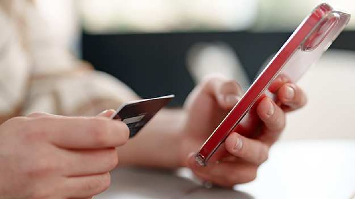 Person entering credit card details on an iPhone