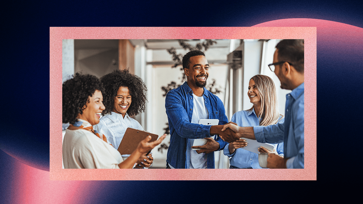 Person shaking hands with his colleagues in a group