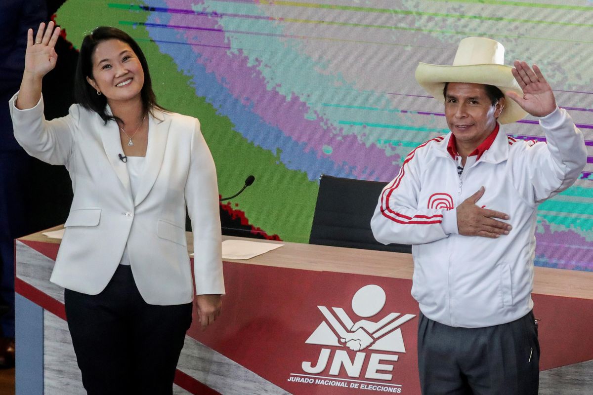 Peru's right-wing candidate Keiko Fujimori and socialist candidate Pedro Castillo wave at the end of their debate ahead of the June 6 run-off election, in Arequipa, Peru May 30, 2021.