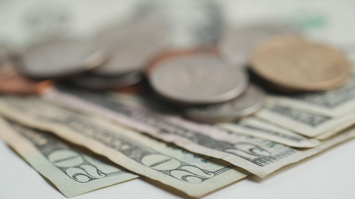 Photo illustration of US dollar bills and coins.