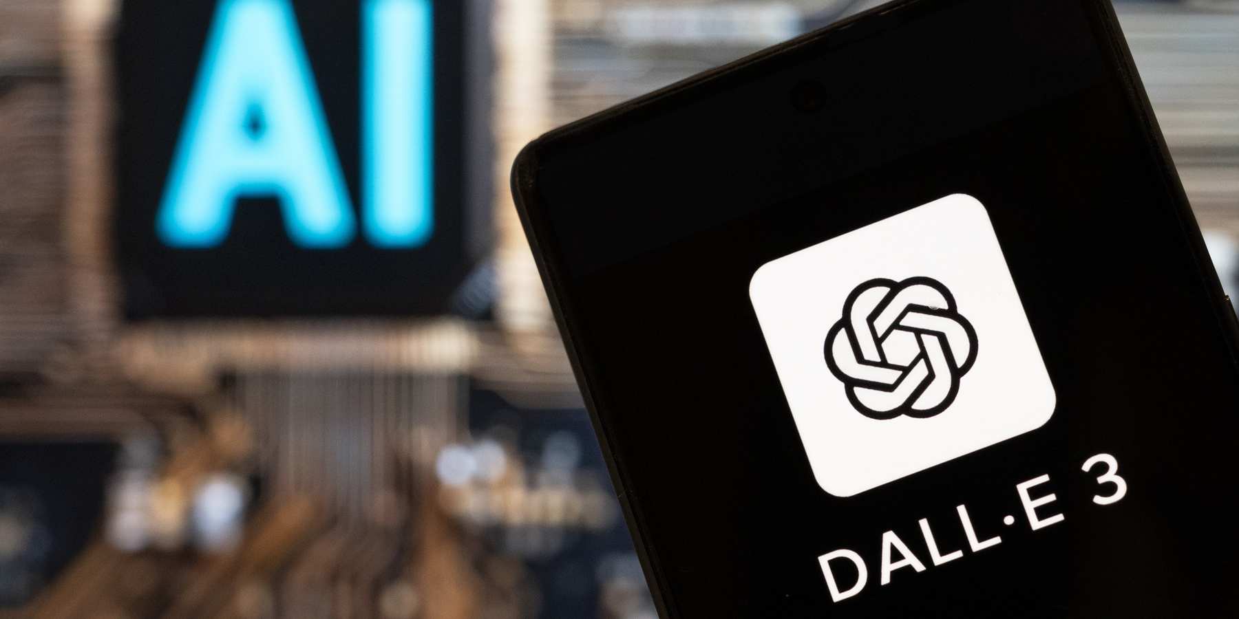 Photo illustration showing the DALL-E logo on a smartphone with an Artificial intelligence chip and symbol in the background.