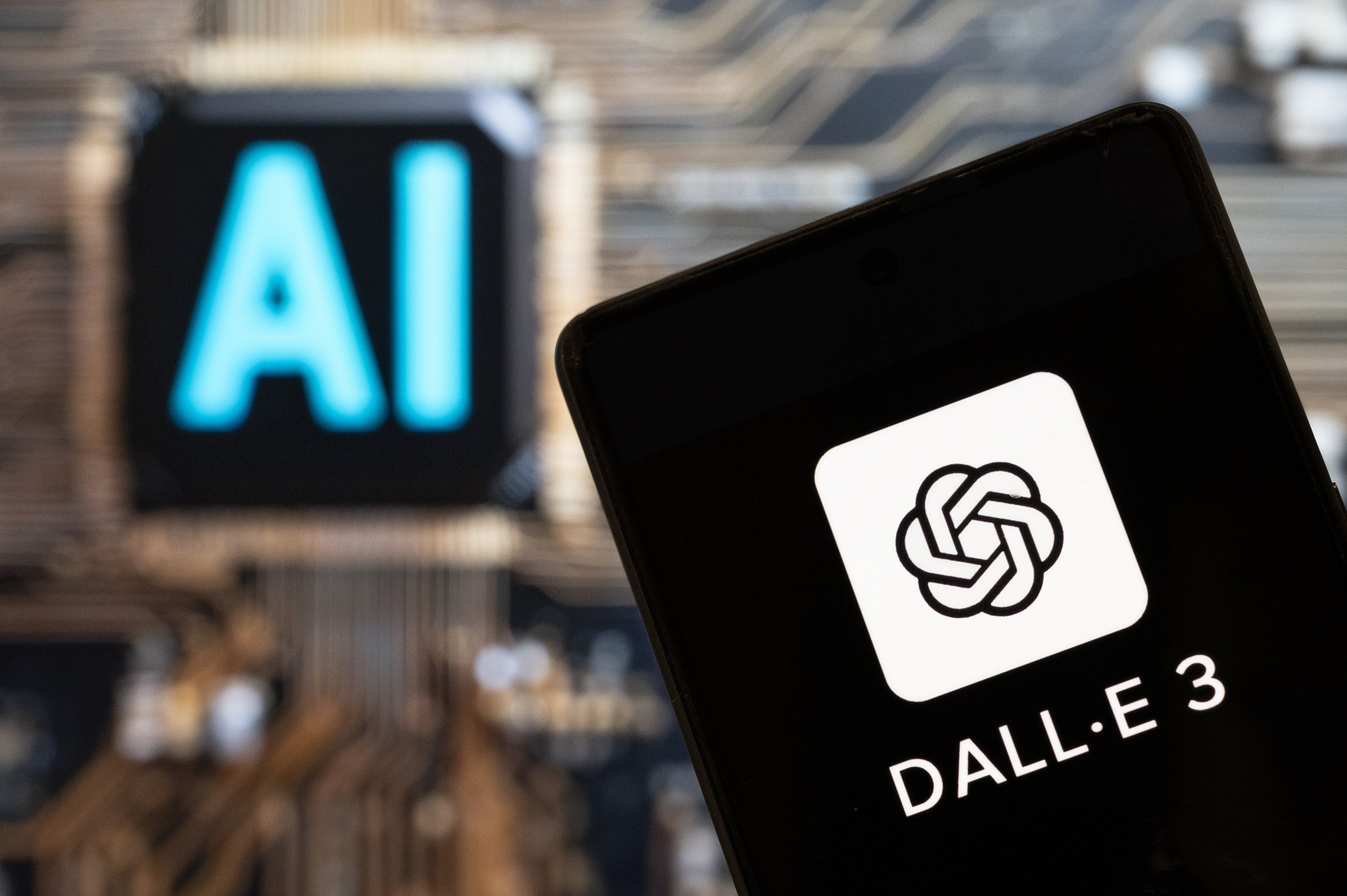 Photo illustration showing the DALL-E logo on a smartphone with an Artificial intelligence chip and symbol in the background.
