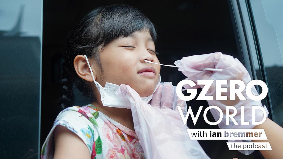 photo of a young girl with black hair and a flowery t-shirt getting swabbed for a COVID test by someone wearing white gloves