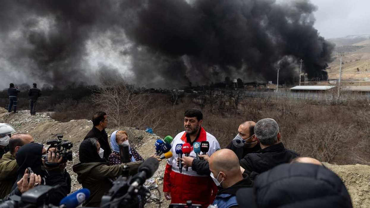 Pirhossein Kolivand, head of the Iranian Red Crescent Society, stands in front of the Shahran oil depot, which was targeted by US-Israeli strikes, in western Tehran, Iran, on March 8, 2026.