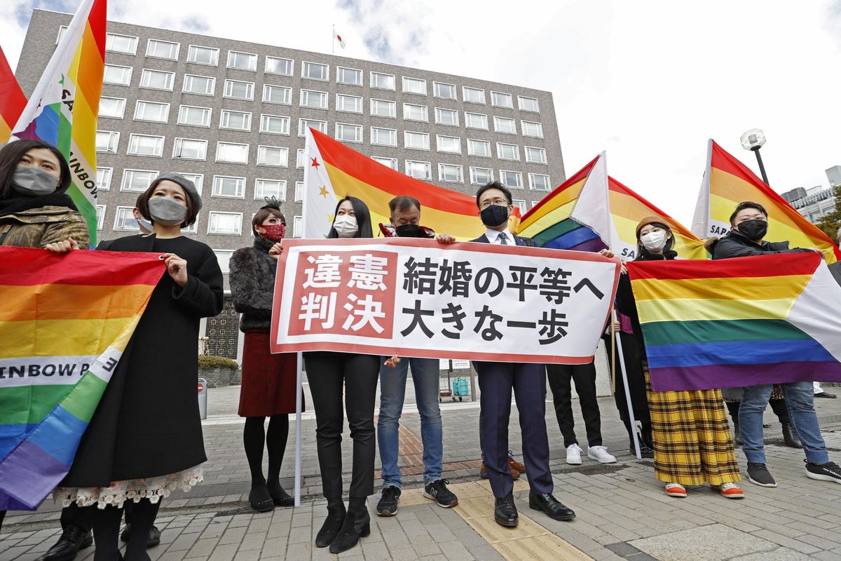 Plaintiffs' lawyers and supporters show a banner that reads 'Unconstitutional decision' after a district court ruled on the legality of same-sex marriages outside Sapporo district court in Sapporo, Hokkaido, northern Japan March 17, 2021