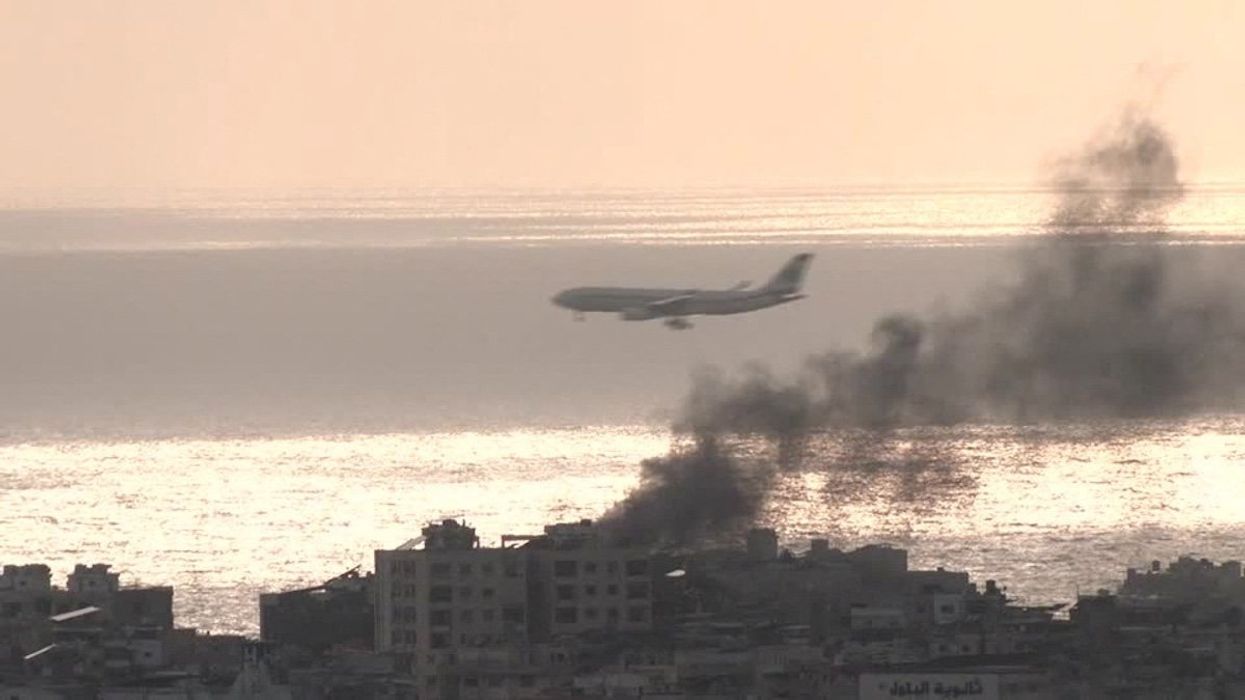 Plane descends through air strike smoke to land at airport in Beirut, Lebanon in this screengrab obtained on October 1, 2024. 