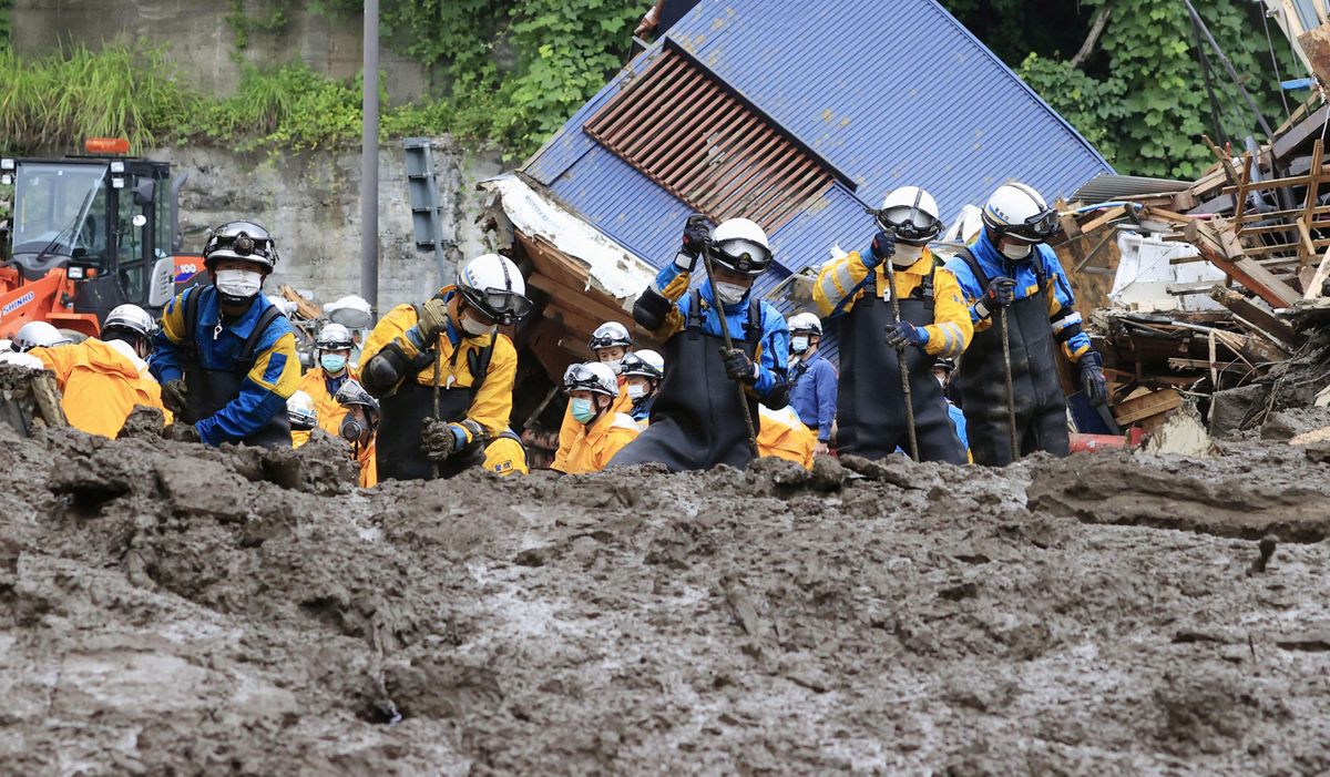 Police officers conduct a rescue and search operation at the site of a mudslide caused by heavy rain at Izusan district in Atami, Japan July 5, 2021, in this photo taken by Kyodo. 