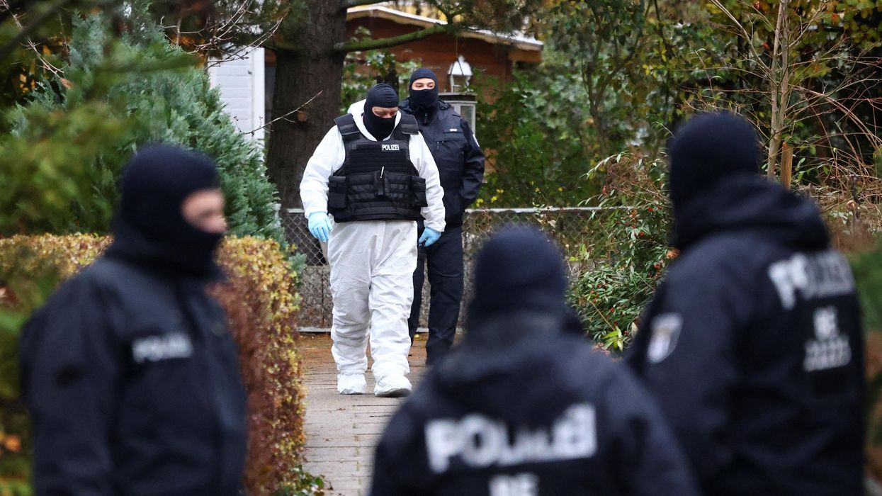 Police secures the area in Berlin after 25 suspected members and supporters of a far-right group were detained during raids across Germany.