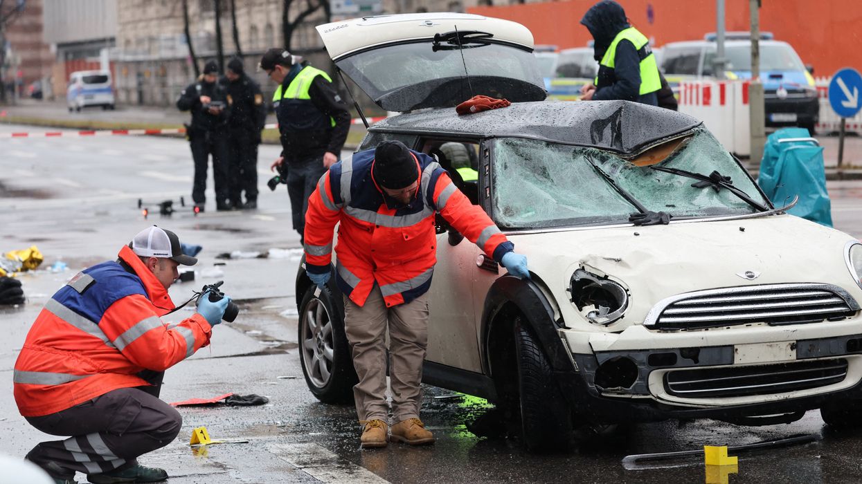 Police takes pictures of a car after some 28 people were hurt when a car driven by an Afghan asylum seeker plowed into a crowd in Munich, Germany, February 13, 2025.