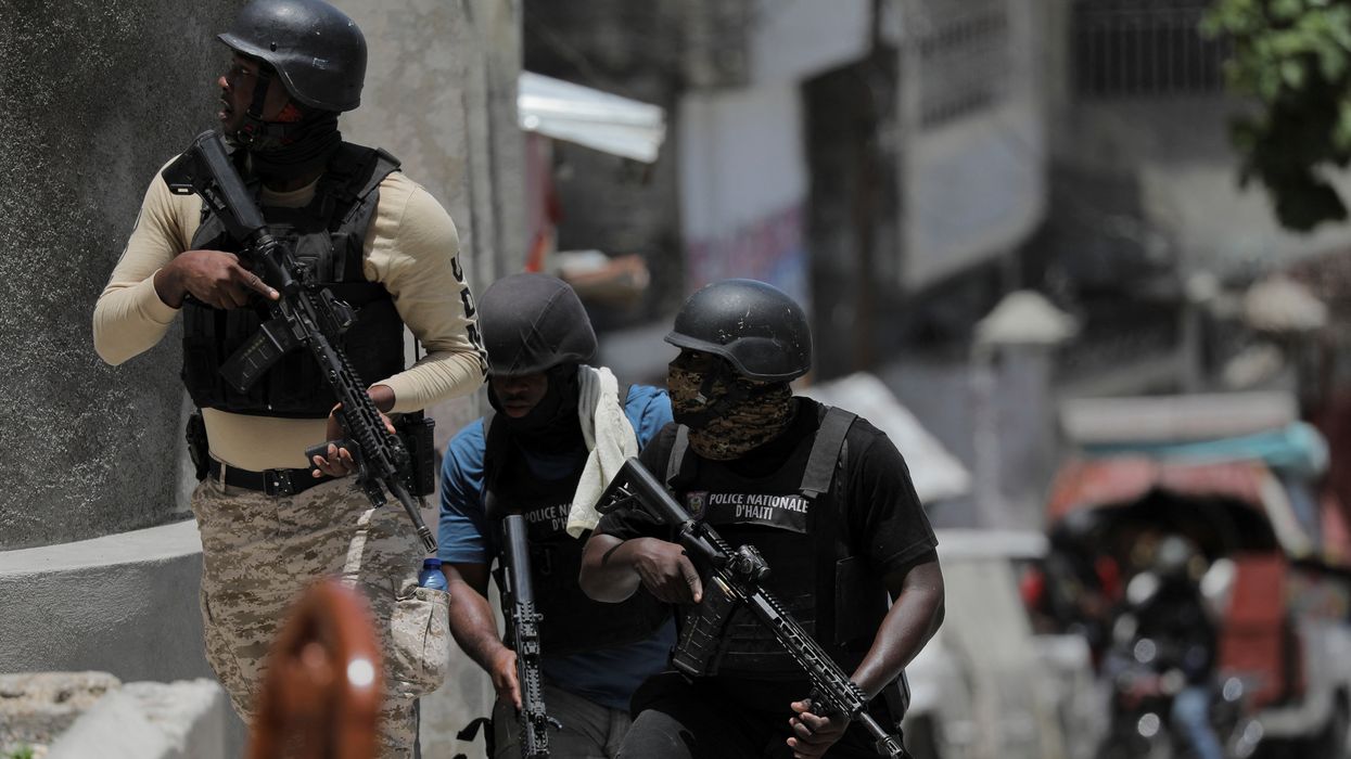Police try to protect residents fleeing the neighbourhood after gangs took over Carrefour Feuilles, in Port-au-Prince, Haiti August 15, 2023.