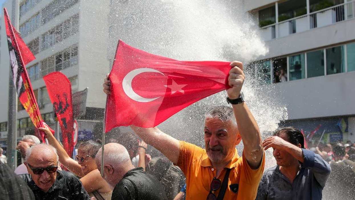 Police use a water cannon during a rally to disperse supporters of Ozgur Ozel
