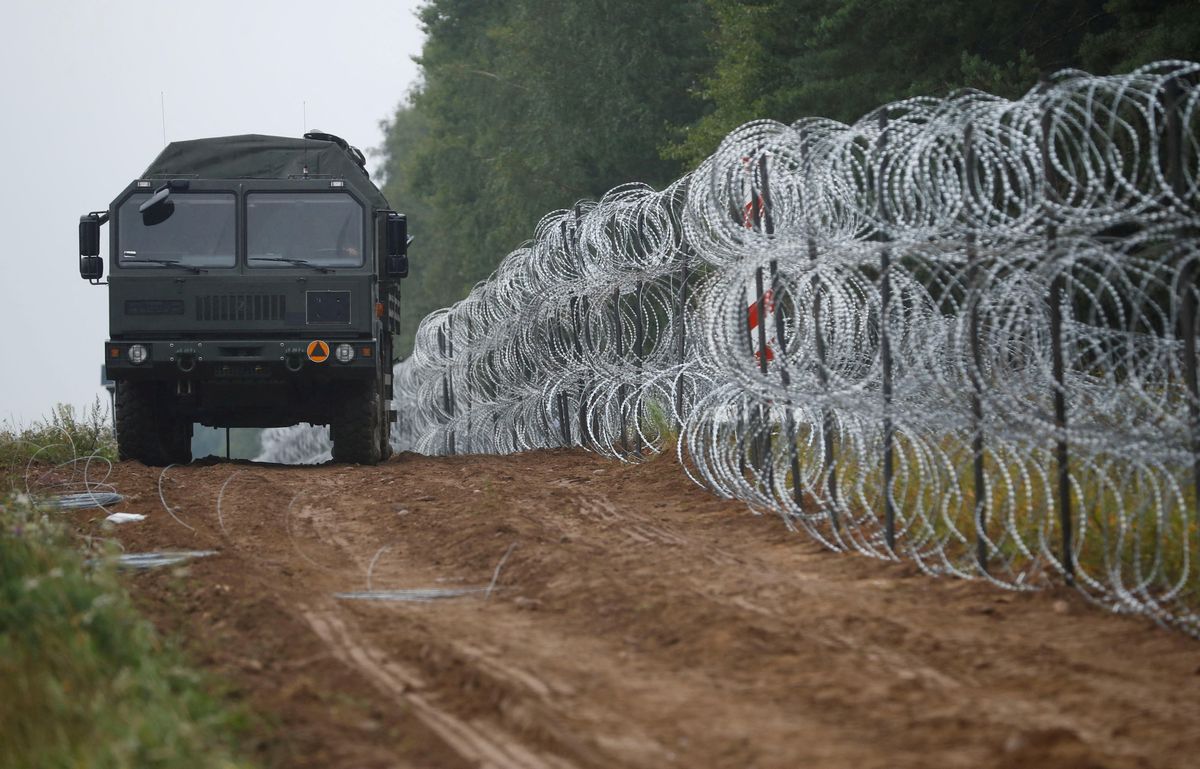 Polish soldiers build a fence on the border between Poland and Belarus near the village of Nomiki. 