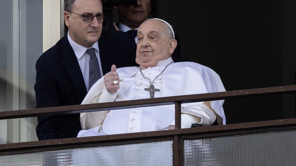​Pope Francis greets the crowd during a short appearance at Gemelli hospital, in Rome, on Sunday, March 23, 2025. 