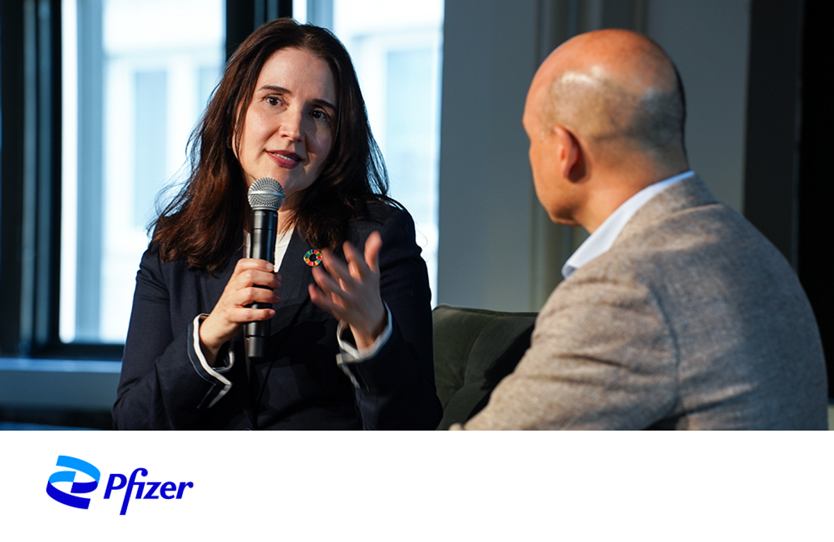 President at Pfizer Foundation Caroline Roan speaking to a man.