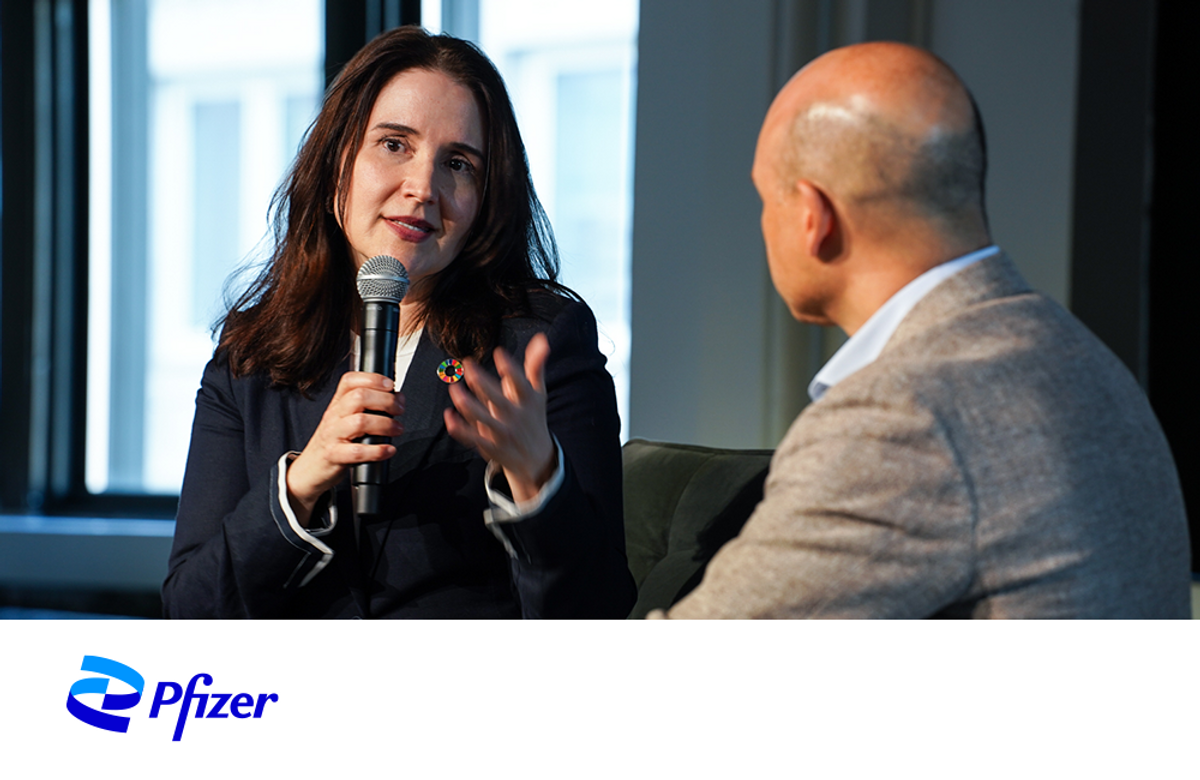 President at Pfizer Foundation Caroline Roan speaking to a man. 