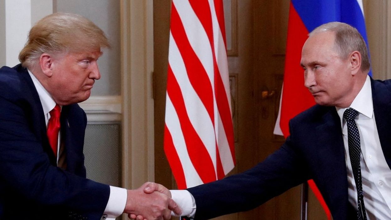 President Donald Trump and Russian President Vladimir Putin shake hands as they meet in Helsinki, Finland, in July 2018.