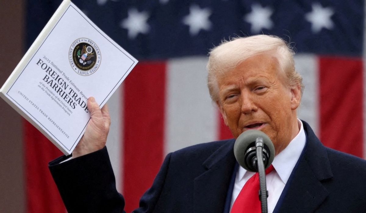 President Donald Trump holds a "Foreign Trade Barriers" document as he delivers remarks on tariffs in the Rose Garden at the White House on April 2, 2025. 