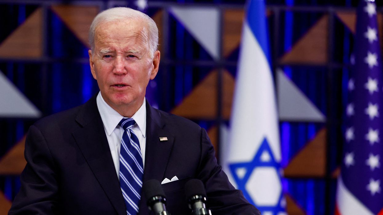 President Joe Biden speaks to the press aboard Air Force One en route from Israel, at Ramstein Air Base, Germany, Oct. 18, 2023.