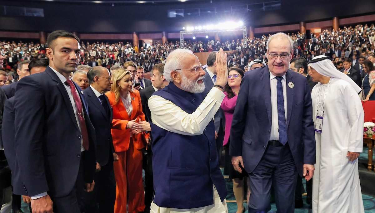 Prime Minister Narendra Modi waves to the crowd during the opening ceremony at AI Impact Summit 2026 at Bharat Mandapam, in New Delhi on Thursday. Switzerland President Guy Parmelin also present. 
