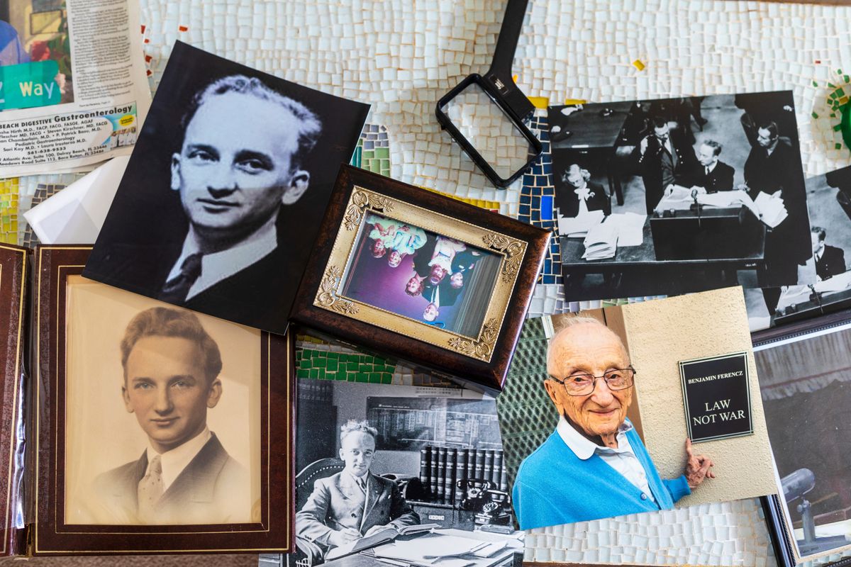Print photocopies of Benjamin Ferencz, while he served as a prosecutor during the Nuremberg trials, on a table at his home in Delray Beach, Florida on June 1, 2022.