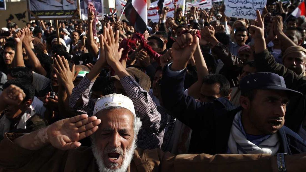 Pro-democracy protesters carry portraits of North Yemen's late president Ibrahim al-Hamdi.