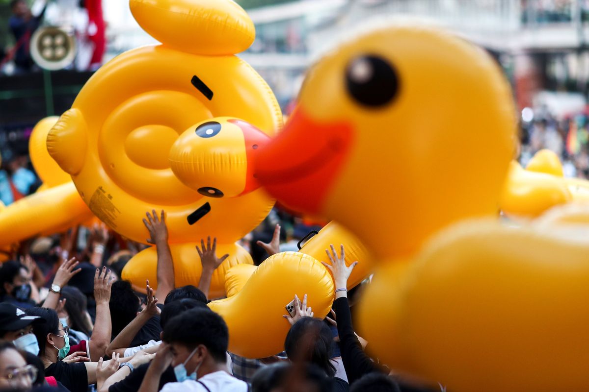 Pro-demonstrators carry inflatable rubber ducks during a rally in Bangkok. Reuters