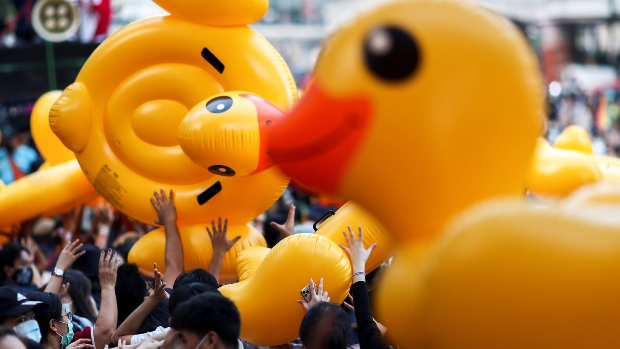 Pro-demonstrators carry inflatable rubber ducks during a rally in Bangkok. Reuters