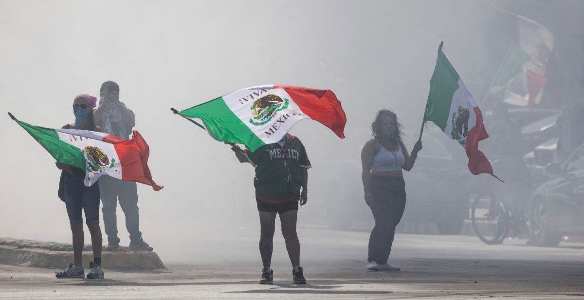 ​Protesters are blanketed in smoke along Alondra Boulevard during a standoff with law enforcement following multiple detentions by Immigration and Customs Enforcement (ICE), in the Los Angeles County city of Compton, California, U.S., June 7, 2025.