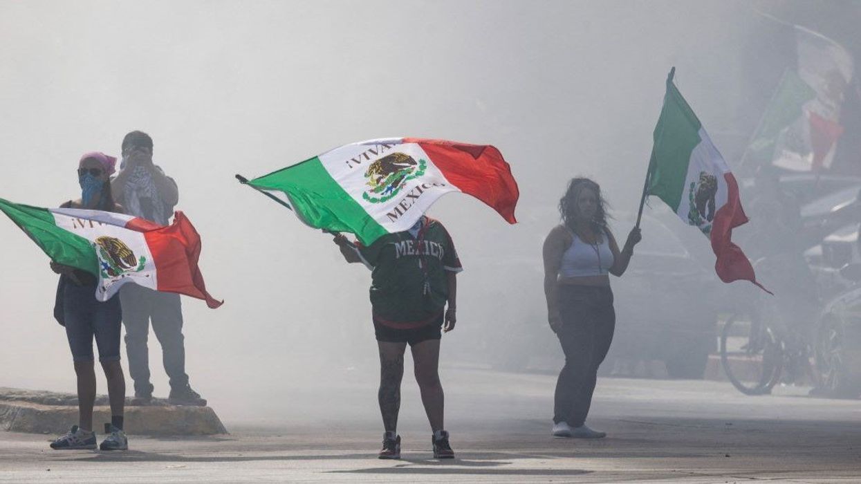 Protesters are blanketed in smoke along Alondra Boulevard during a standoff with law enforcement following multiple detentions by Immigration and Customs Enforcement (ICE), in the Los Angeles County city of Compton, California, U.S., June 7, 2025.