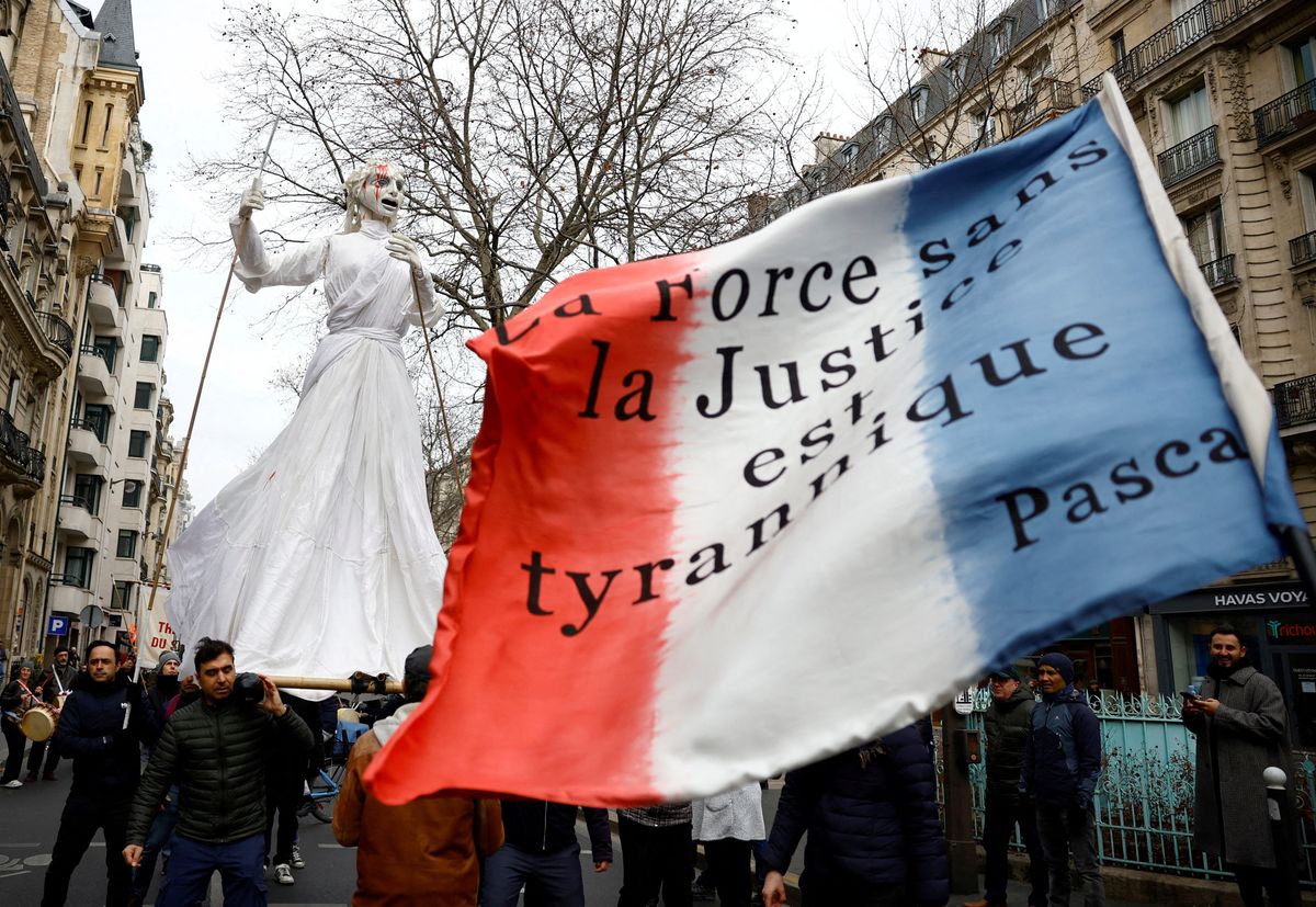 Protesters attend a demonstration against the French government's pension reform plan in Paris.