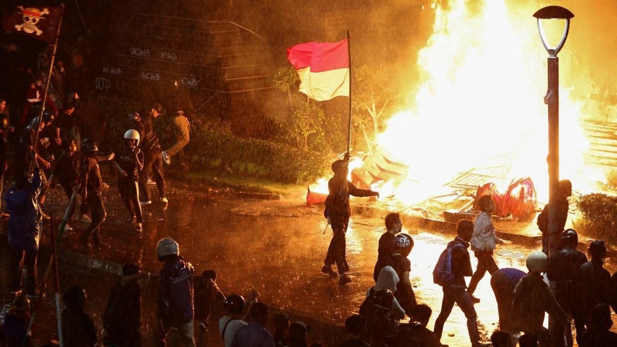 Protesters carry an Indonesian flag and a flag from Japanese anime 'One Piece' during a protest in Jakarta, Indonesia, on August 29, 2025.