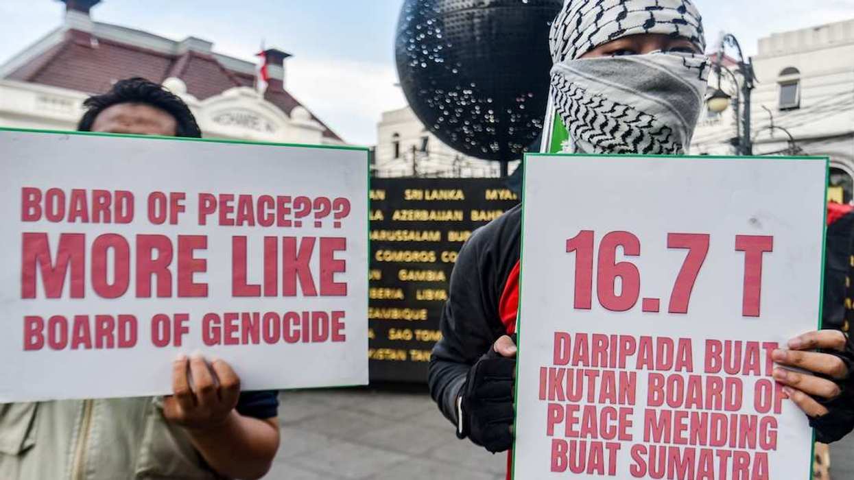 Protesters carry posters during a demonstration in support of Palestine at the Asia-Africa Monument in Bandung, West Java. They demand the Indonesian government's immediate withdrawal from the Board of Peace and express solidarity with the people of Gaza and Palestine involved in the conflict with Israel.