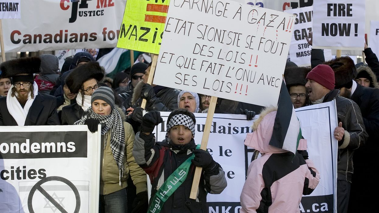 Protesters carry signs during a march calling for the end of the Israeli attacks in Gaza in downtown Montreal.